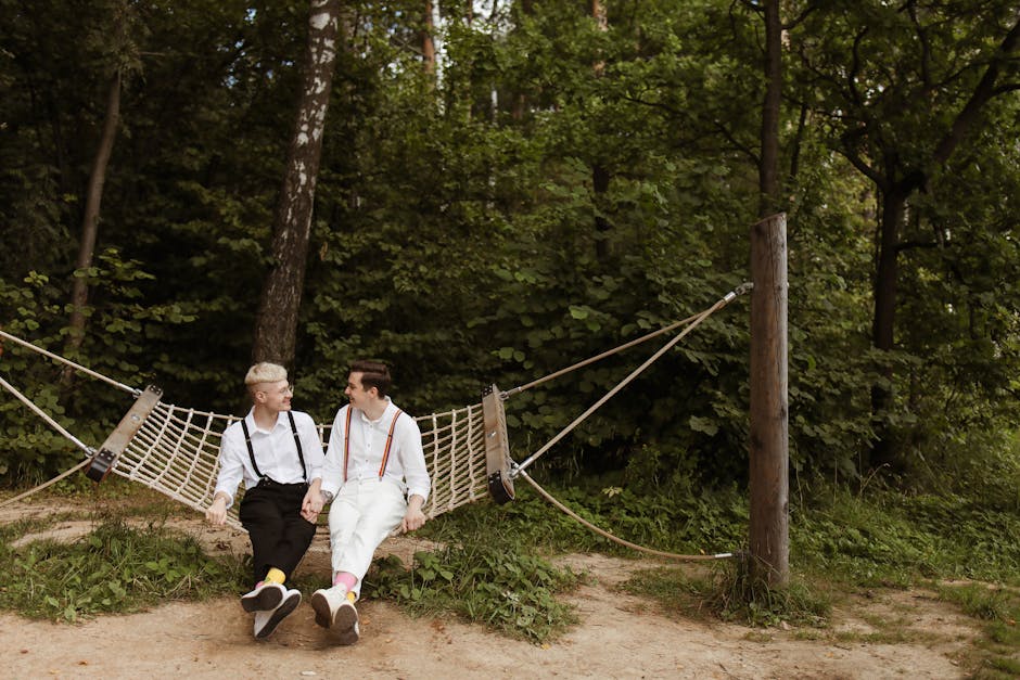 Two men in love sitting in a hammock in a lush forest, enjoying nature and each other's company.